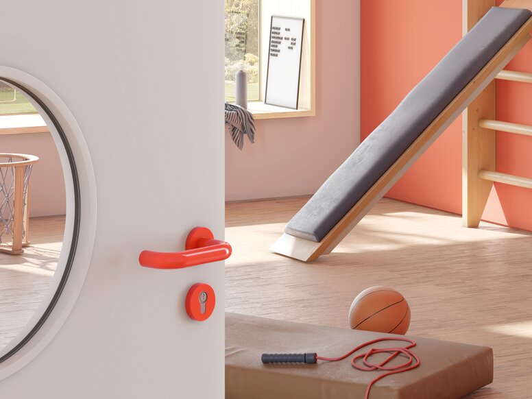 Door to a sports room of a kindergarten equipped with a lever handle in the colour orange made of polyamide